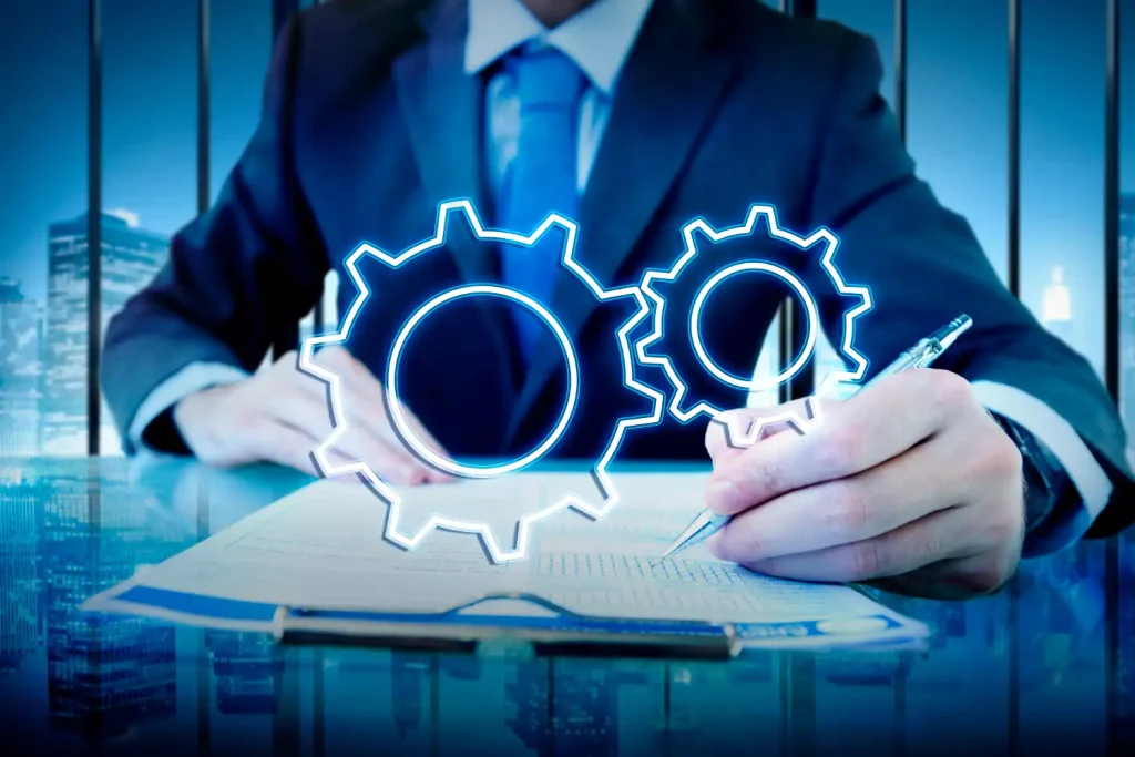 Imagem de um executivo de negócios analisando gráficos de engrenagens holográficas para decidir entre gestão de manutenção preditiva e preventiva, destacando critérios de escolha de estratégia.