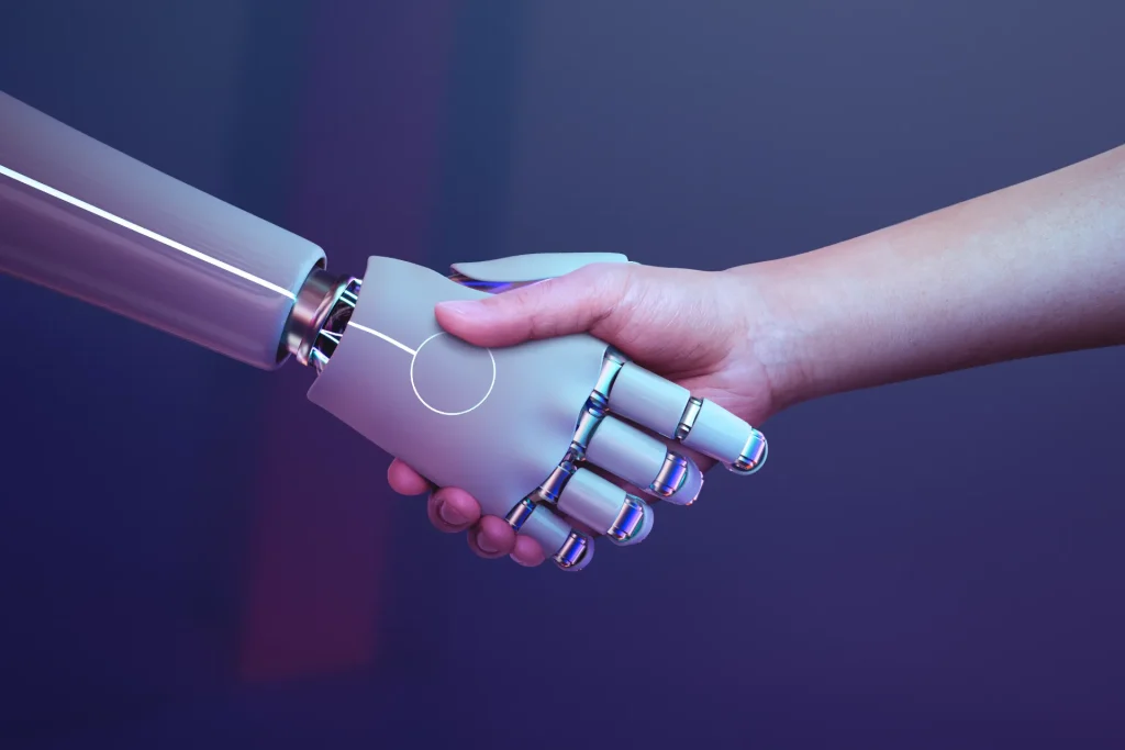 Dois braços estendidos em um aperto de mão entre humano e um braço robótico, com destaque para a tecnologia e a colaboração; visão de como a Inteligência Artificial está transformando pequenas empresas brasileiras em 2026.