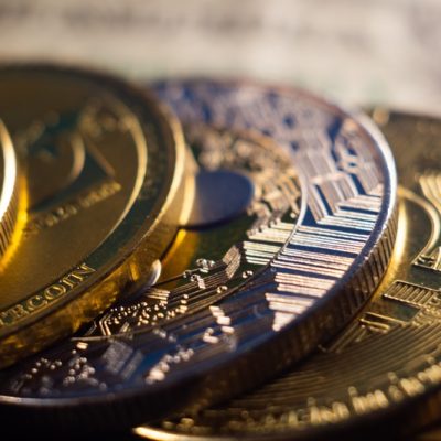 a closeup shot of a pile of cryptocurrency cash golden coins