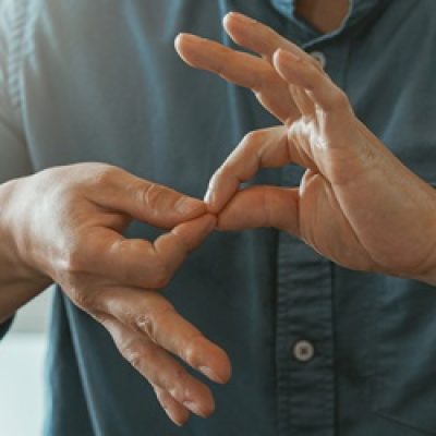 Close up of businessman using sign language while talking with client in office. High quality photo