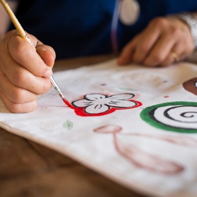 Girl use brush paint picture on bag