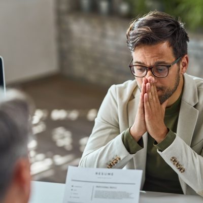 Distraught young man feeling uncertain while having a job interview in the office. - Reprodução | Magnific
